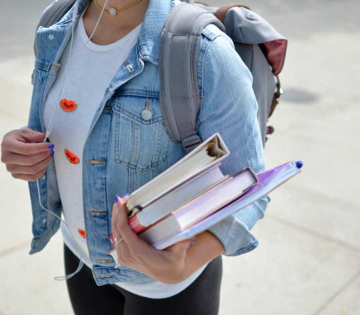 A female student carries books