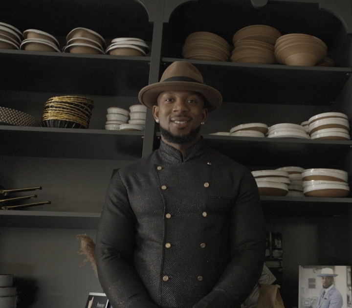 Darian Bryan stands in front of shelves of dishes