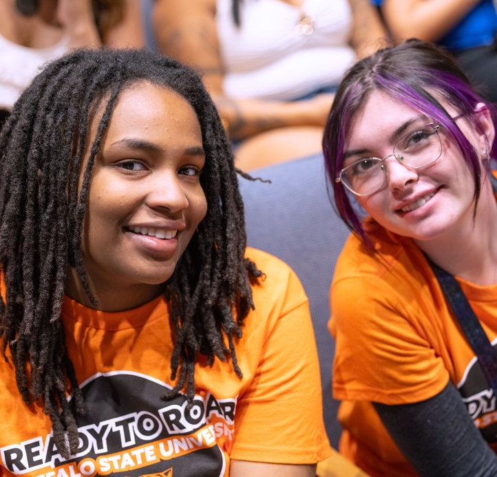 Two students sitting in the PAC