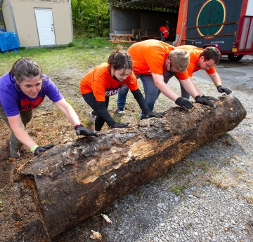 Students rolling a log
